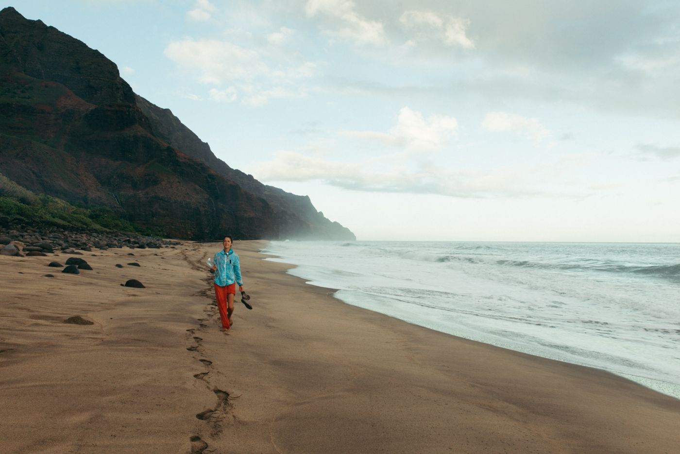 Woman walking Kalalau Beach, Kalalau Trail, Kaua'i, Hawaii