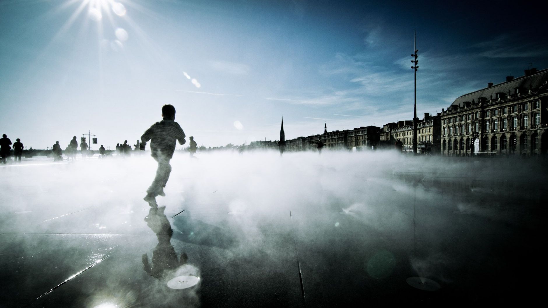 Boy running through the mist on the Water Mirror, Bordeaux
