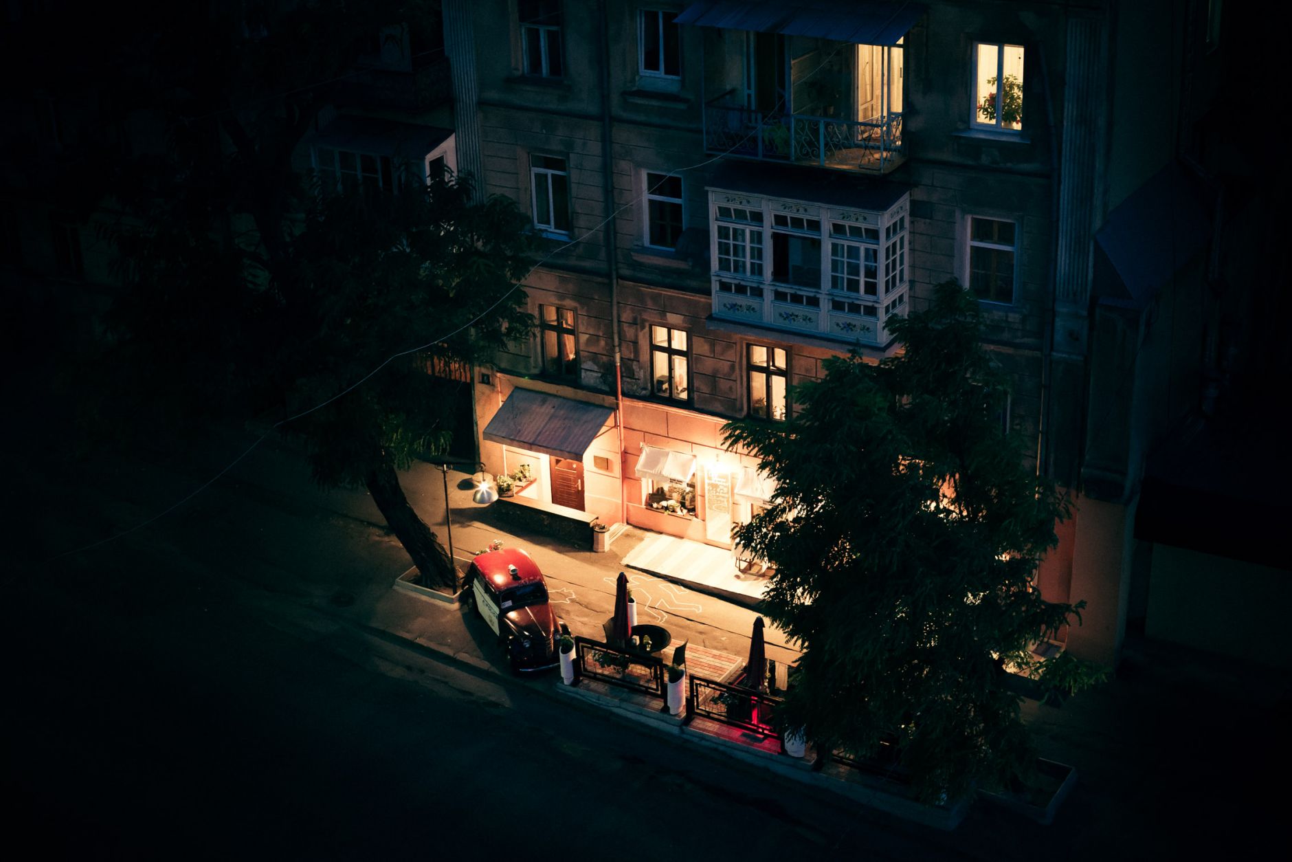 Shot from above of a restaurant in Odessa, Ukraine. Silhouette drawn with chalk on the pavement.